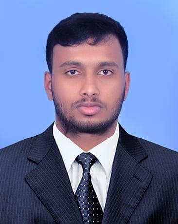 Shjill Varghese, Design Engineer in formal black pinstripe suit with white shirt and dark patterned tie